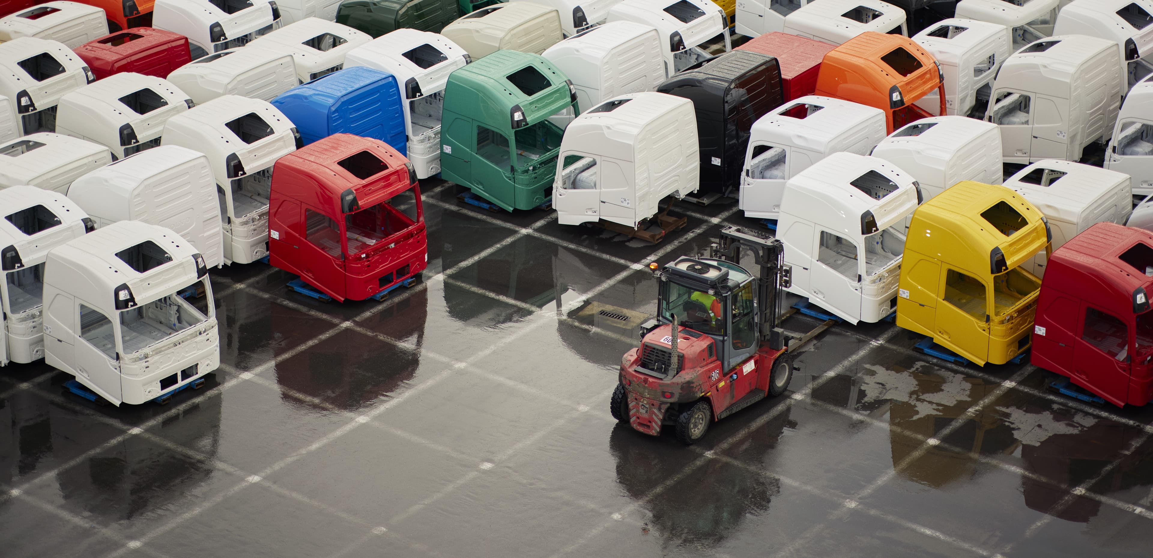 DFDS truck houses in parking lot in different colors