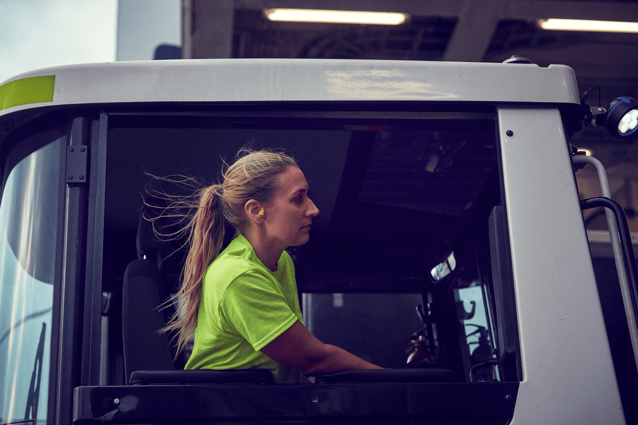 A woman driving a DFDS truck.