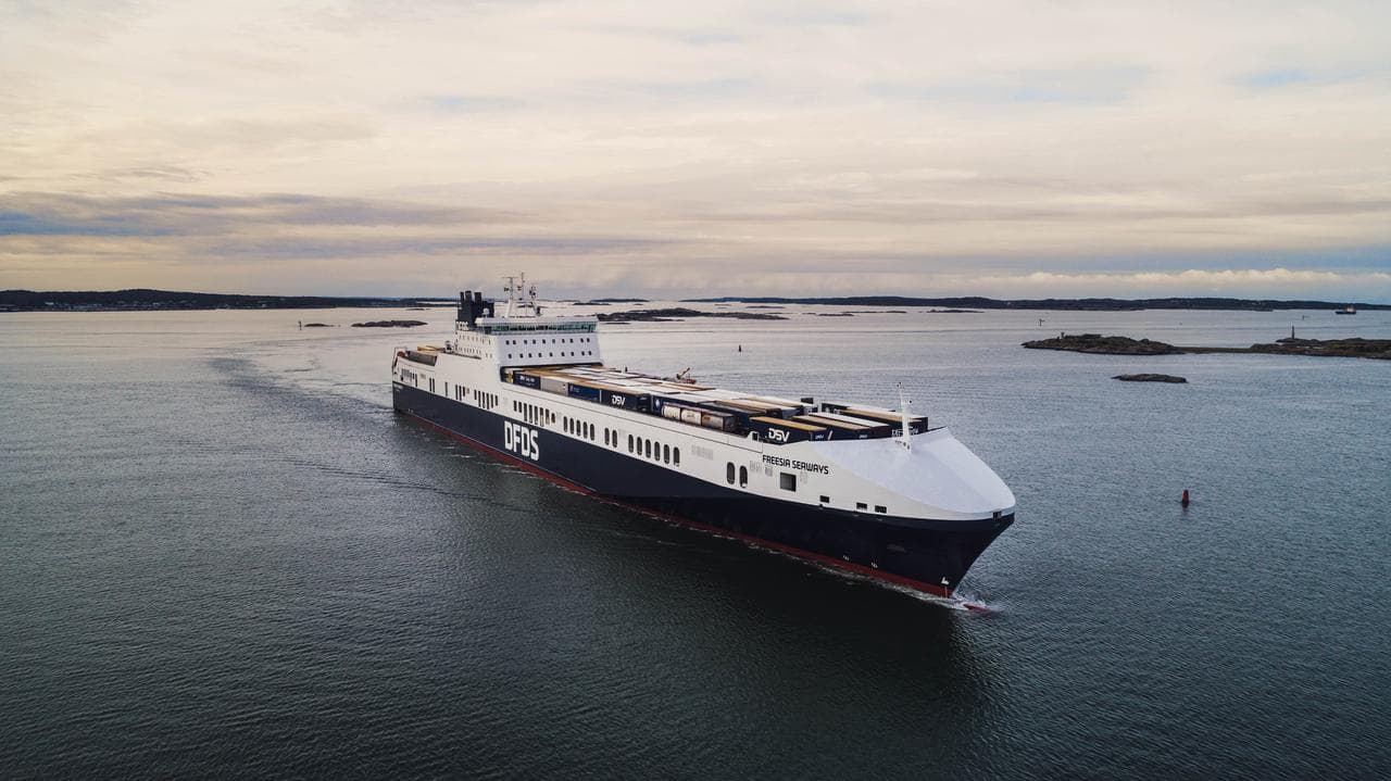 Photo of a DFDS freight ship at sea in the morning dawn