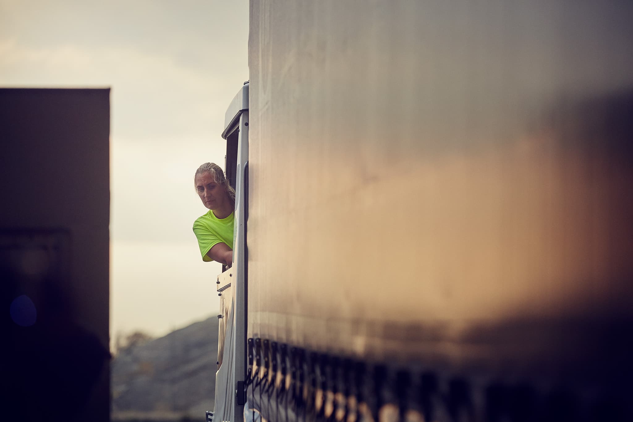 DFDS woman inside truck cabin looking at the trailer