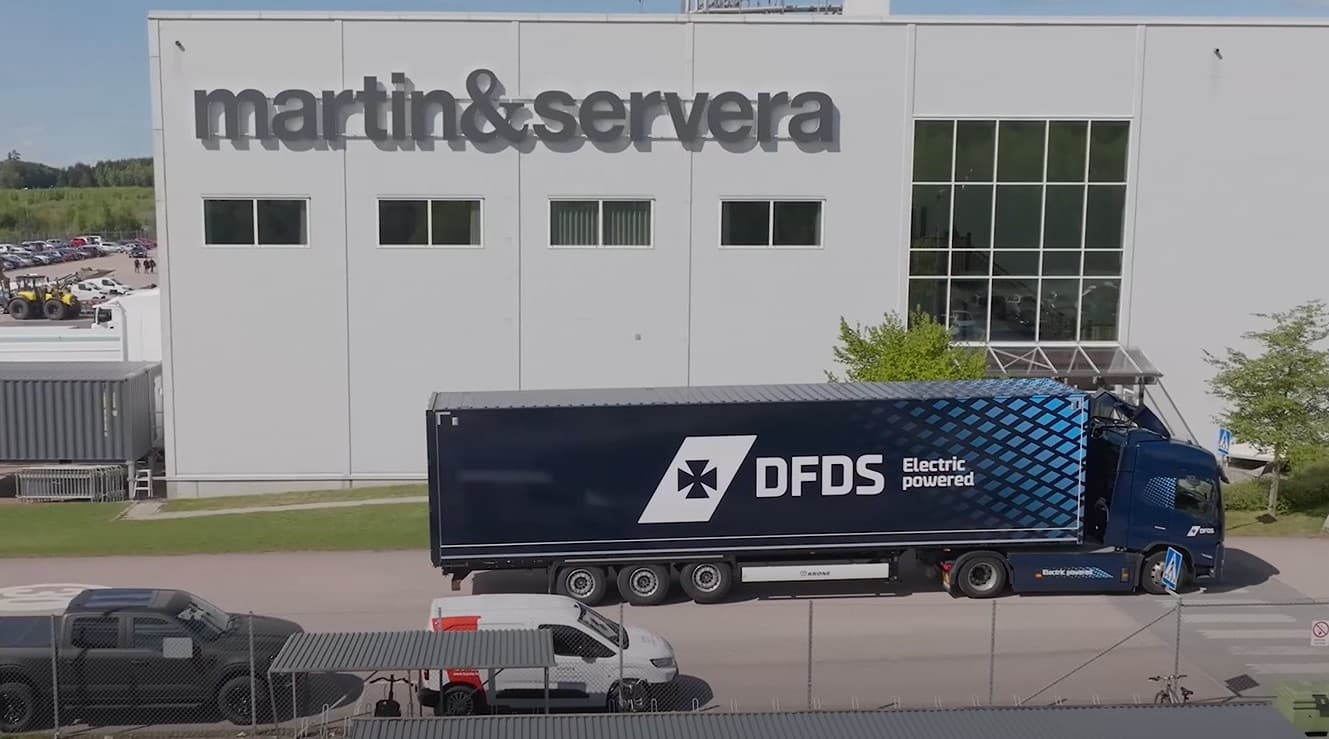 DFDS truck in front of a Martin & Servera building in Sweden.